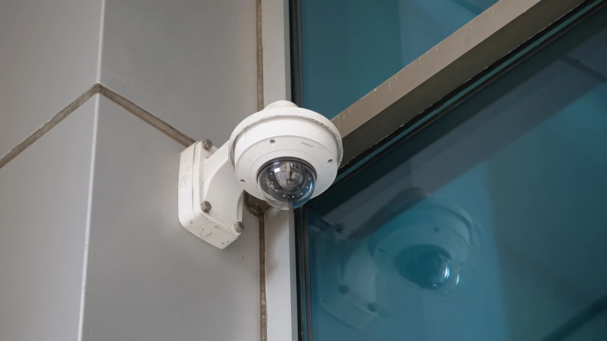 Business security camera mounted in corner.